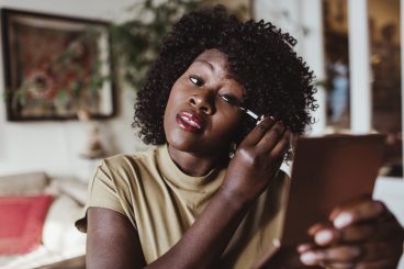 Mature Afro Woman Applying Mascara At Home