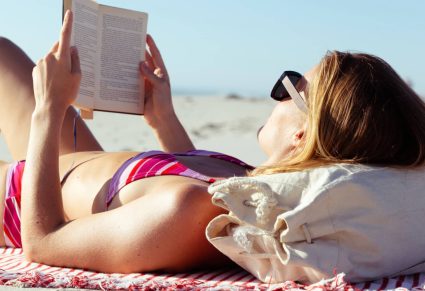 Aangrijpende Romans: vrouw leest boek op het strand