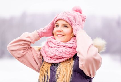 Roze Sjaals: Jonge vrolijke vrouw met roze sjaal om geniet van de besneeuwde winter